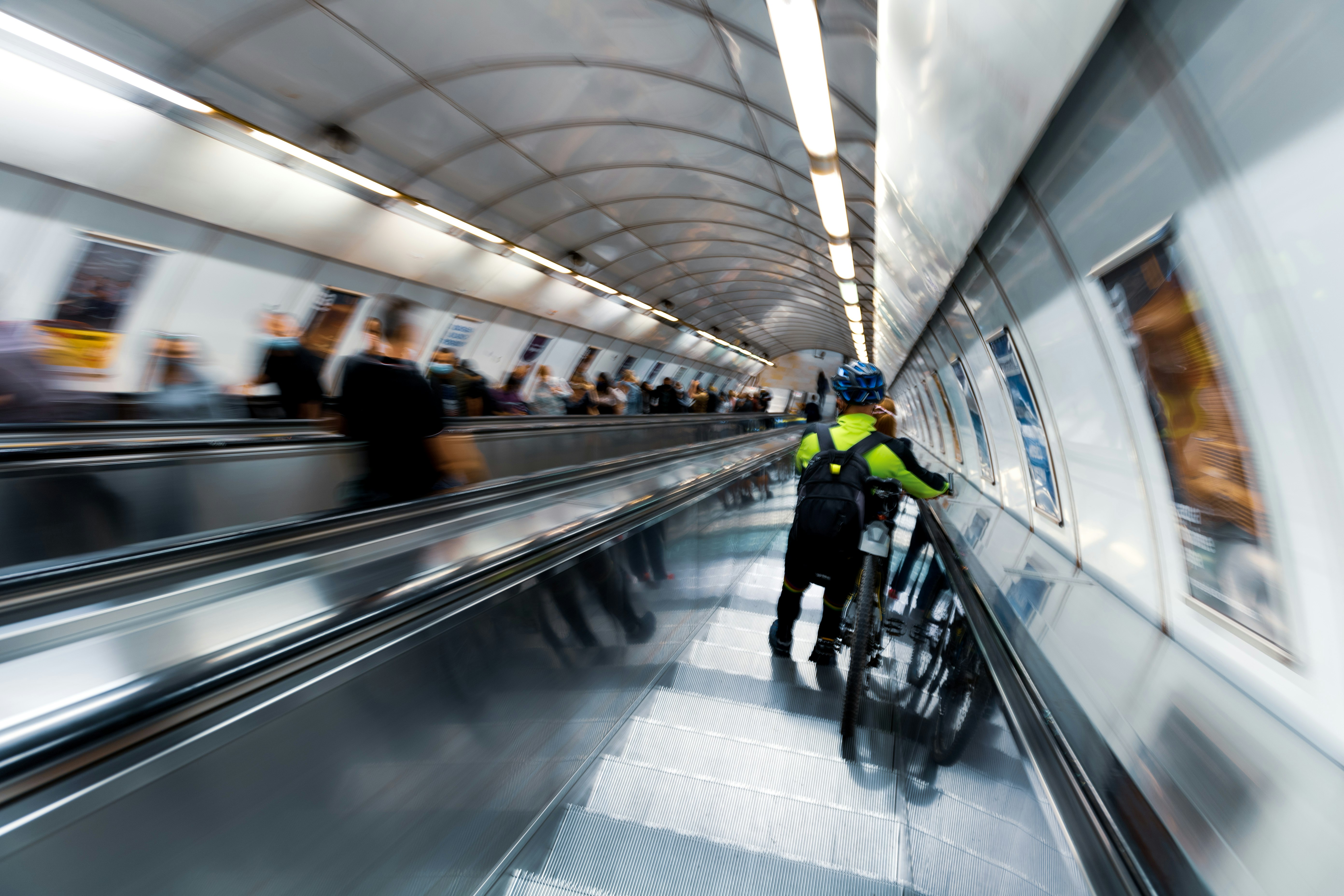 people walking on escalator inside building